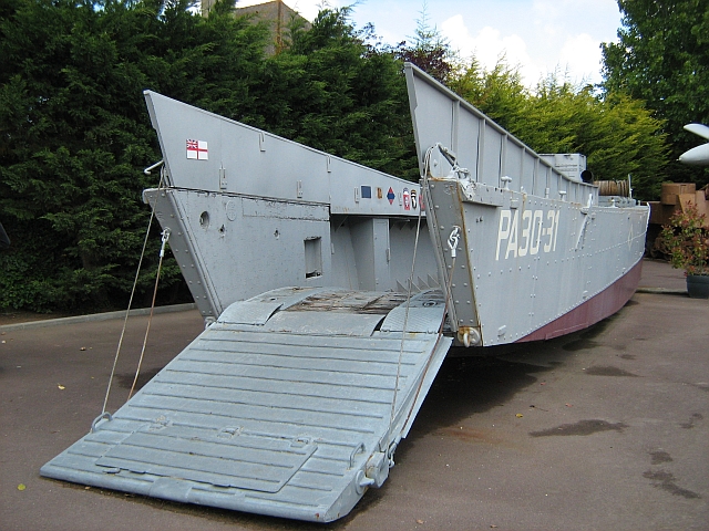 long grey d-day landing craft outside the grand bunker ouistreham